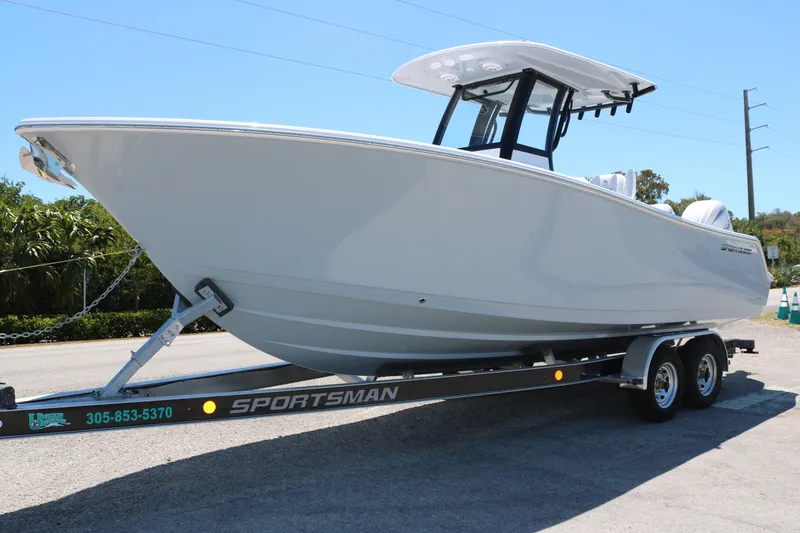Slide: The Image of 2025 Sportsman Open 252 Center Console boat on trailer, parked outdoors. - 0
