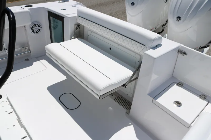 Slide: The Image of 2025 Sportsman Open 252 Center Console boat with white seating and storage compartments. - 14