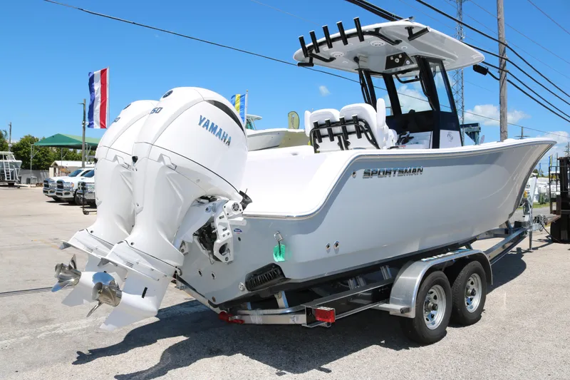 Slide: The Image of 2025 Sportsman Open 252 Center Console boat on trailer with twin Yamaha engines. - 3
