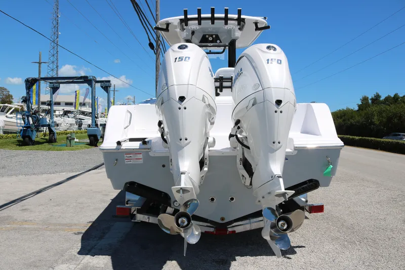 Slide: The Image of 2025 Sportsman Open 252 Center Console with dual outboard engines, rear view. - 4