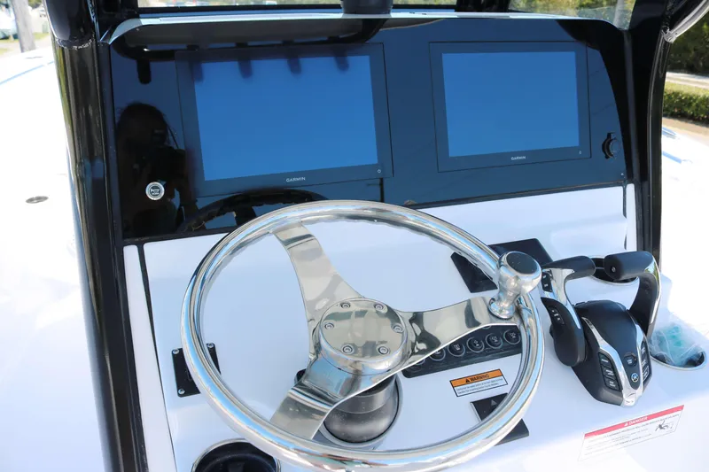 Slide: The Image of 2025 Sportsman Open 252 Center Console dashboard with dual screens and steering wheel. - 6