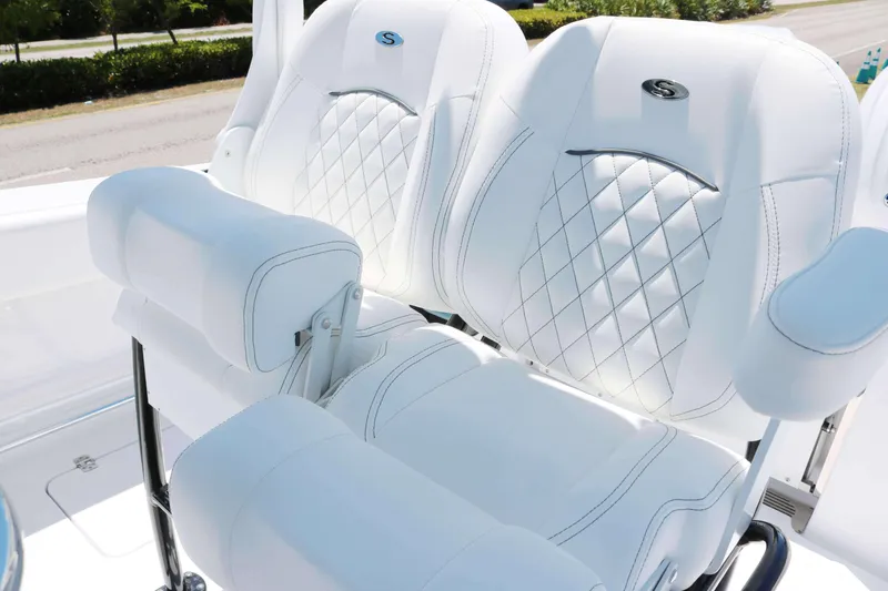 Slide: The Image of 2025 Sportsman Open 252 Center Console boat seats with white diamond stitching. - 7
