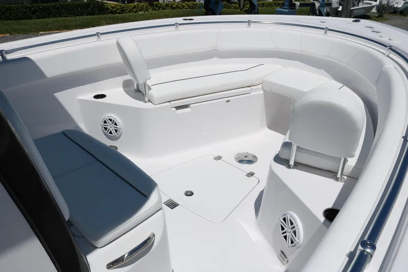 Slide: The Image of 2025 Sportsman Open 252 Center Console boat interior with white seating and speakers. - 8
