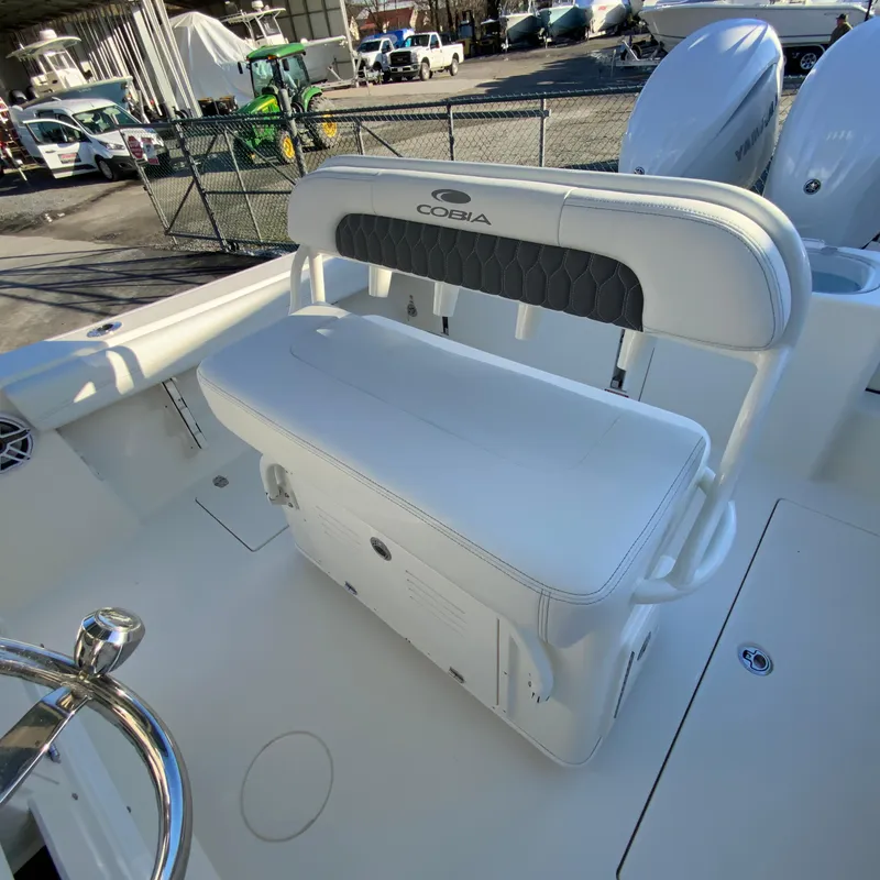 Slide: The Image of 2025 Cobia 240 Center Console boat with white seating and storage. - 14