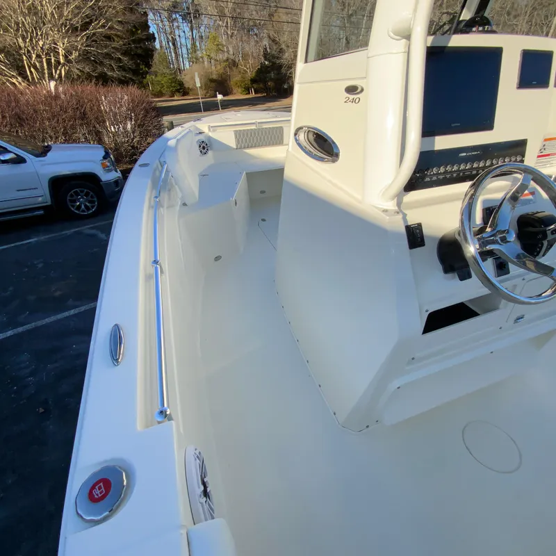 Slide: The Image of 2025 Cobia 240 Center Console boat interior with steering wheel and dashboard. - 18