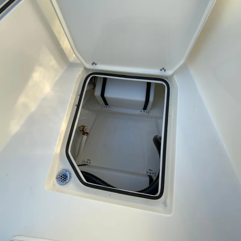 Slide: The Image of Open storage compartment on 2025 Cobia 240 Center Console boat. - 21