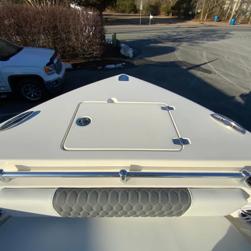 Slide: The Image of 2025 Cobia 240 Center Console boat bow with storage hatch and cushioned seating. - 24