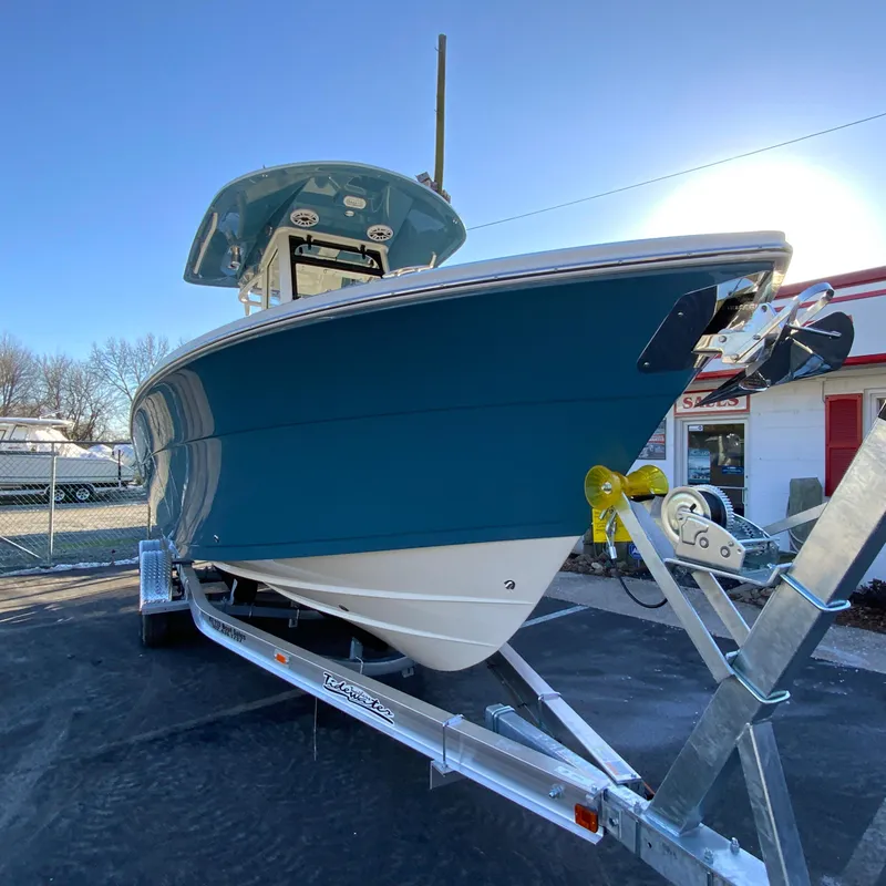 Slide: The Image of 2025 Cobia 240 Center Console boat on trailer, displayed outdoors. - 3
