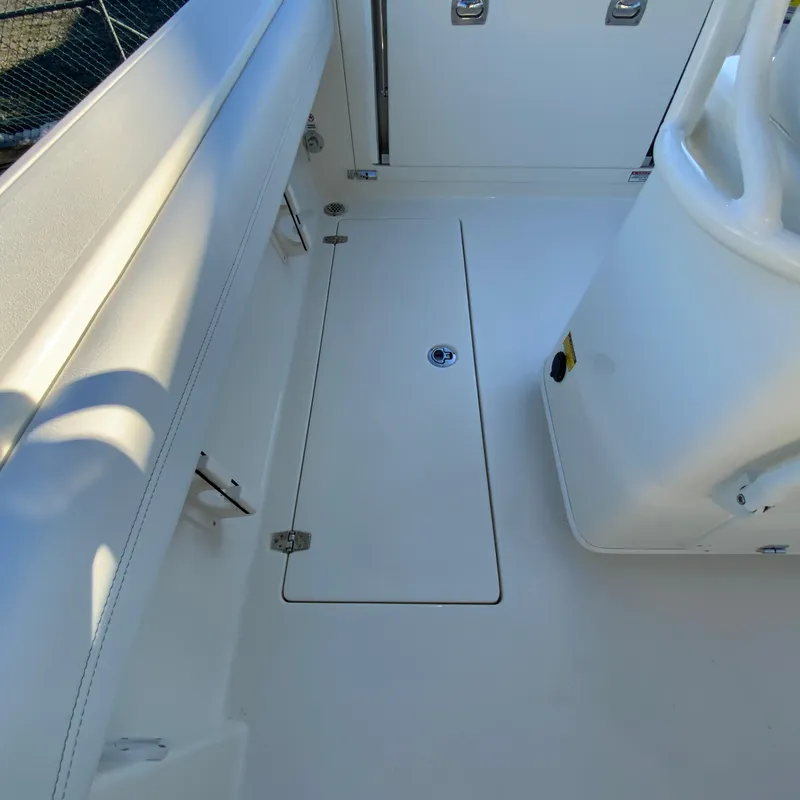 Slide: The Image of 2025 Cobia 240 Center Console boat interior, featuring sleek white deck design. - 32