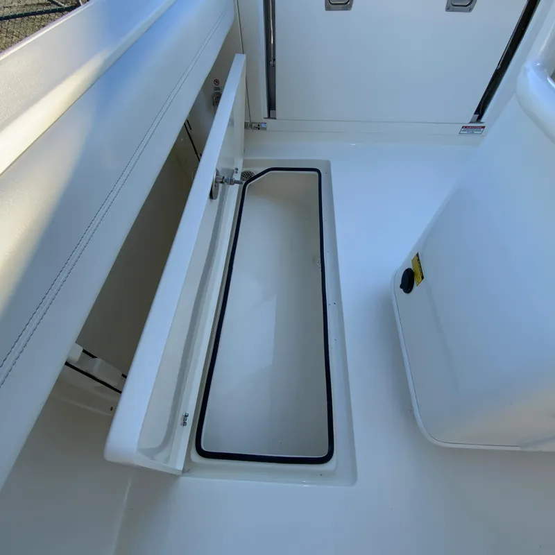 Slide: The Image of 2025 Cobia 240 Center Console boat storage compartment, open and empty. - 33