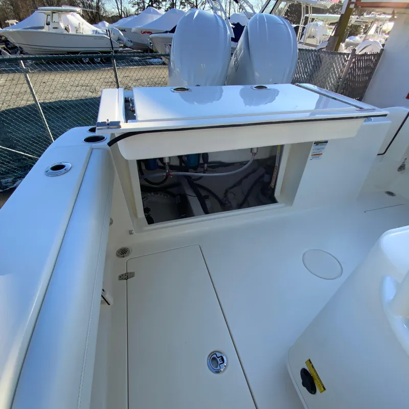 Slide: The Image of 2025 Cobia 240 Center Console boat interior with open storage compartment. - 34
