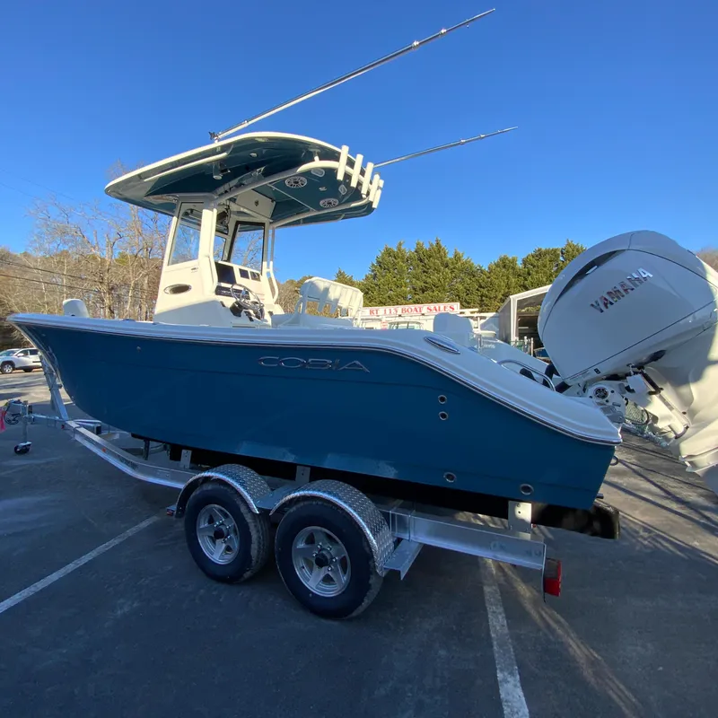 Slide: The Image of 2025 Cobia 240 Center Console boat on trailer, featuring Yamaha outboard motor. - 7