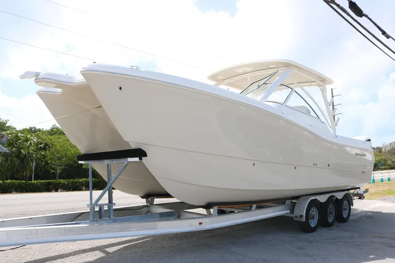 The Image of 2025 World Cat 296DC boat on a trailer, parked outdoors. - 0