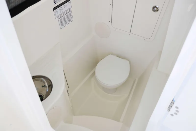 Slide: The Image of 2025 World Cat 296DC boat interior bathroom with toilet and sink. - 11