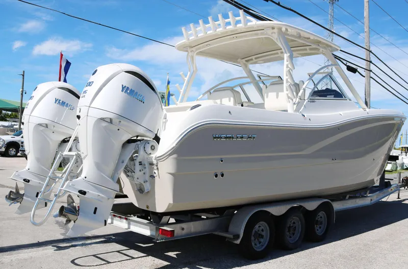 Slide: The Image of 2025 World Cat 296DC boat on trailer with dual Yamaha engines. - 3