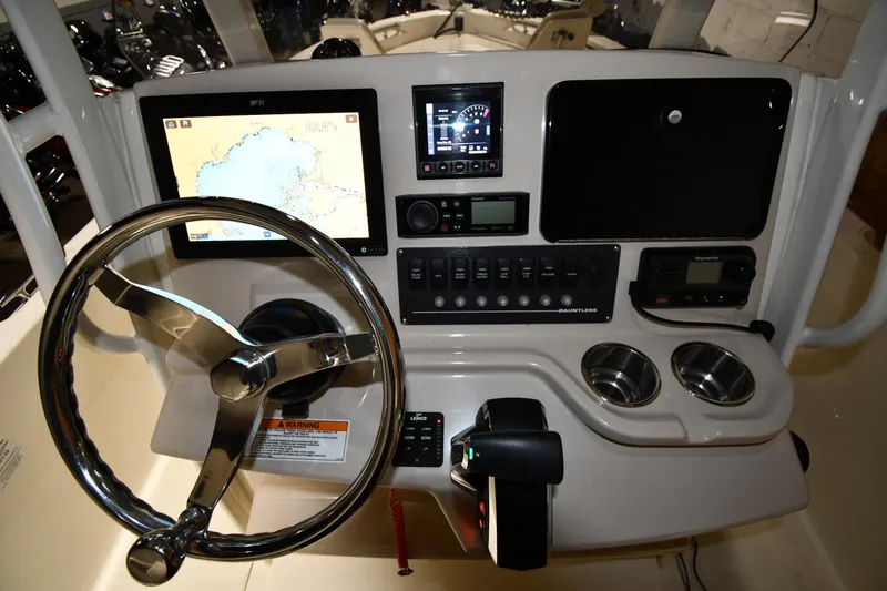 Slide: The Image of 2022 Boston Whaler 250 Dauntless helm with navigation screens and controls. - 19