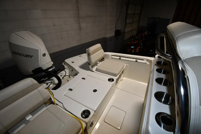 Slide: The Image of 2022 Boston Whaler 250 Dauntless boat interior with seating and Mercury engine. - 27