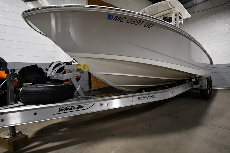 Slide: The Image of 2022 Boston Whaler 250 Dauntless boat on trailer in garage. - 3
