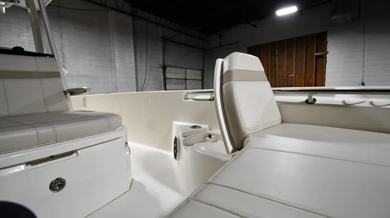 Slide: The Image of 2022 Boston Whaler 250 Dauntless interior with white seating in a dimly lit space. - 36