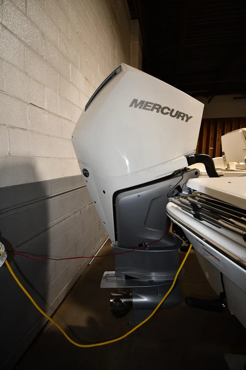 Slide: The Image of 2022 Boston Whaler 250 Dauntless with Mercury outboard engine in a showroom. - 6