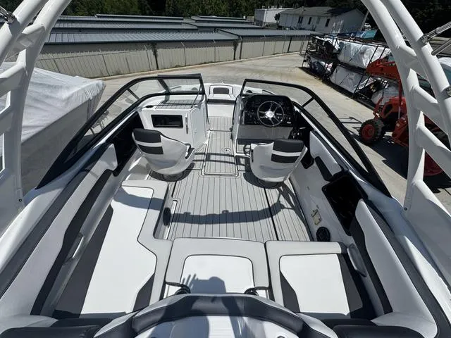 Slide: The Image of 2025 Yamaha Boats 195 S on a serene lake with swimmers nearby. - 4