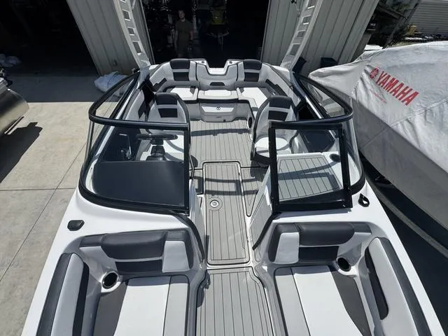 Slide: The Image of 2025 Yamaha Boats 195 S on a serene lake at dusk, surrounded by lush trees. - 8