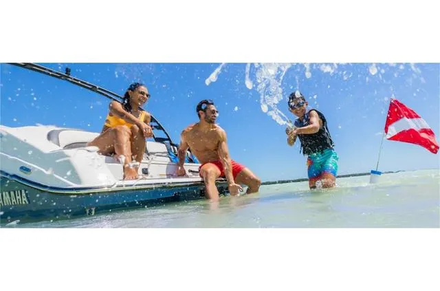 Slide: The Image of 2024 Yamaha Boats 195S with people enjoying water activities. - 3