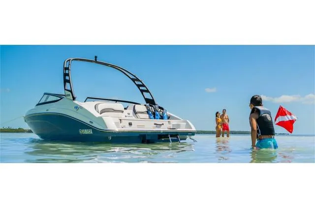 Slide: The Image of 2024 Yamaha Boats 195S in shallow water with people enjoying the beach. - 5