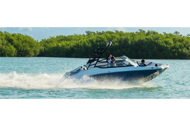 Slide: The Image of 2024 Yamaha Boats 195S speeding on water with lush greenery in the background. - 6