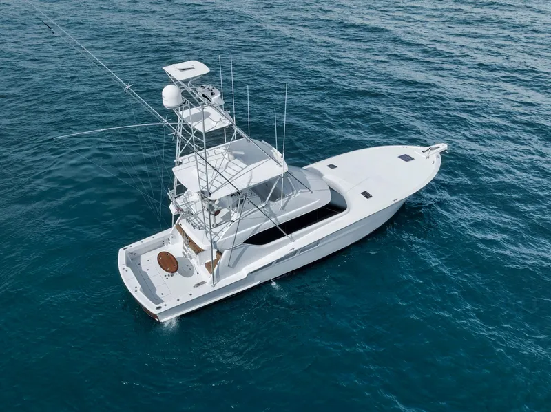 Slide: The Image of 1999 Hatteras 60 Convertible yacht on open water, aerial view. - 10