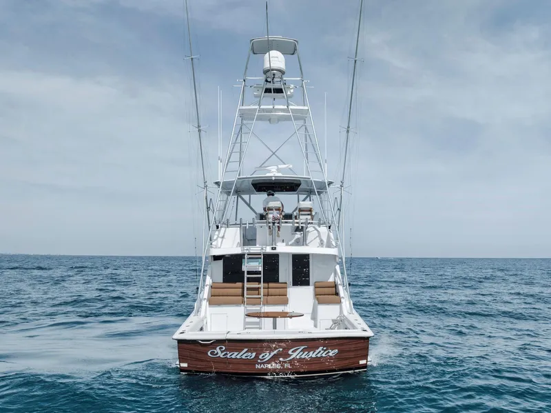 Slide: The Image of 1999 Hatteras 60 Convertible yacht on open sea, rear view. - 11