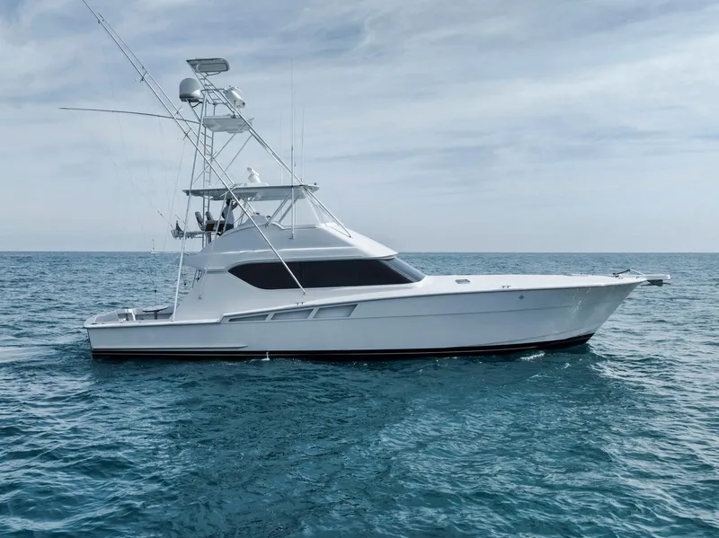 Slide: The Image of 1999 Hatteras 60 Convertible yacht cruising on open sea. - 15