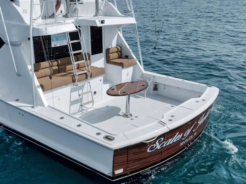 Slide: The Image of 1999 Hatteras 60 Convertible yacht with spacious deck and seating on the ocean. - 16