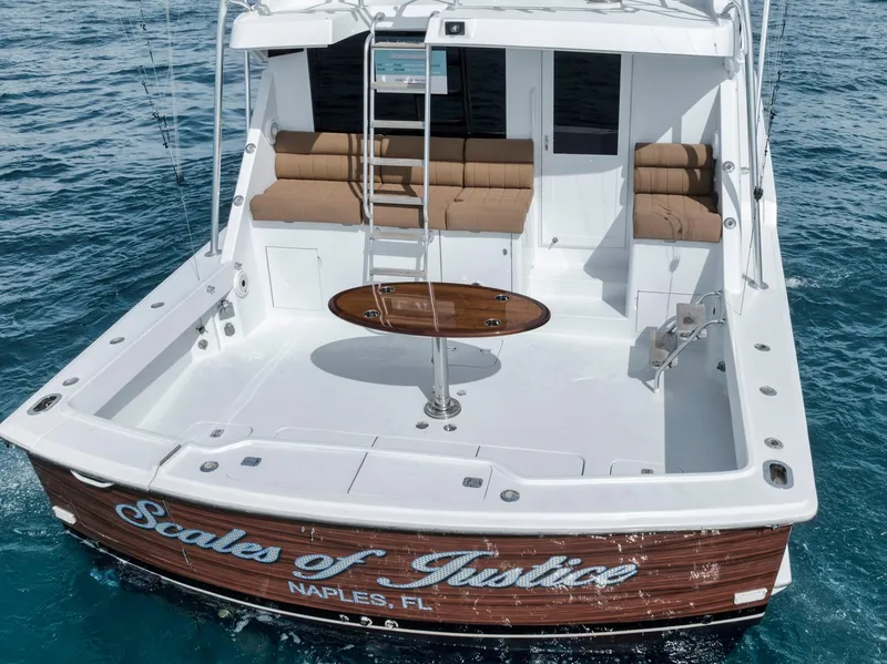 Slide: The Image of 1999 Hatteras 60 Convertible yacht on water, rear view, named "Scales of Justice," Naples, FL. - 17