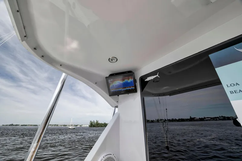 Slide: The Image of 1999 Hatteras 60 Convertible yacht interior with water view and navigation screen. - 20