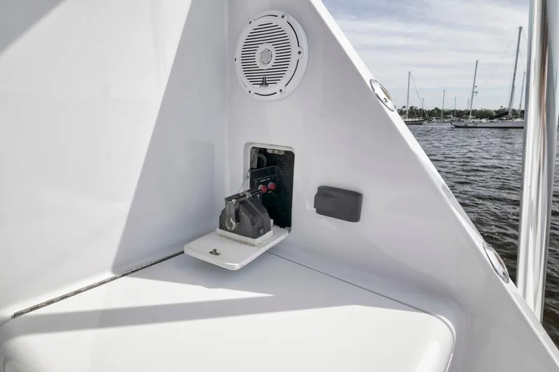 Slide: The Image of 1999 Hatteras 60 Convertible yacht detail with speaker and control panel, docked by the water. - 21