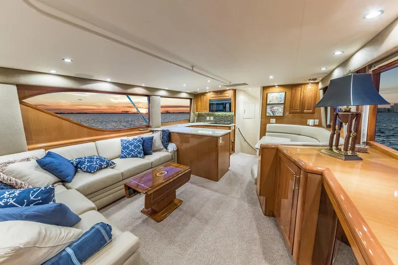 Slide: The Image of Luxurious interior of 1999 Hatteras 60 Convertible yacht with elegant furnishings and ocean view. - 23