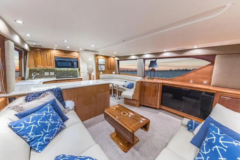Slide: The Image of Luxurious interior of 1999 Hatteras 60 Convertible yacht with elegant furnishings and scenic view. - 24