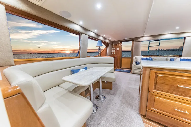 Slide: The Image of Interior of 1999 Hatteras 60 Convertible yacht with elegant seating and ocean view. - 27