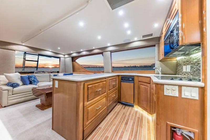 Slide: The Image of Luxurious interior of 1999 Hatteras 60 Convertible yacht with modern kitchen and sunset view. - 28