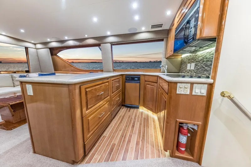 Slide: The Image of Luxurious interior of 1999 Hatteras 60 Convertible yacht with modern kitchen and ocean view. - 29