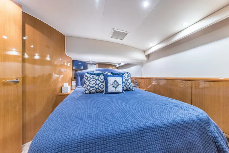 Slide: The Image of Luxurious cabin interior of 1999 Hatteras 60 Convertible yacht with blue bedding. - 32