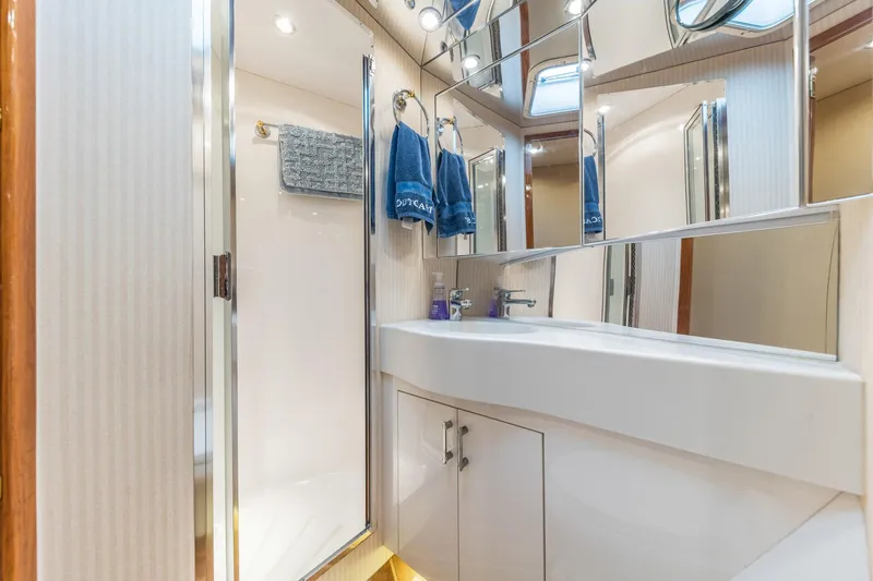 Slide: The Image of Bathroom interior of 1999 Hatteras 60 Convertible yacht, featuring modern fixtures and ample lighting. - 33