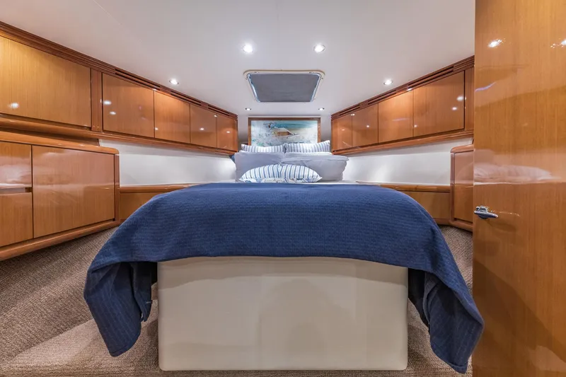 Slide: The Image of Luxurious cabin interior of 1999 Hatteras 60 Convertible yacht with blue bedding. - 34