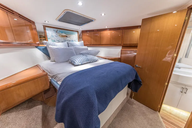 Slide: The Image of Luxurious bedroom in 1999 Hatteras 60 Convertible yacht with elegant wood finishes. - 36