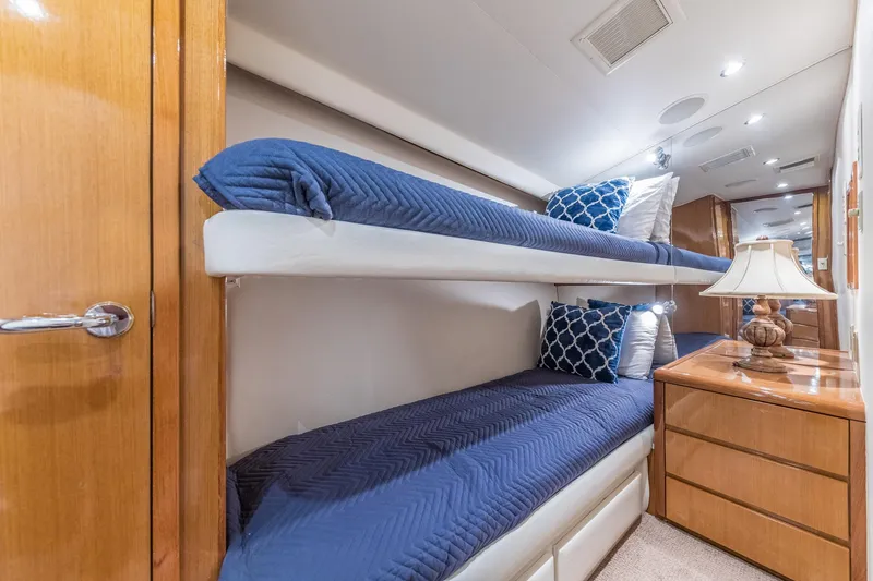 Slide: The Image of Bunk beds in 1999 Hatteras 60 Convertible yacht cabin with blue bedding and wooden furnishings. - 38