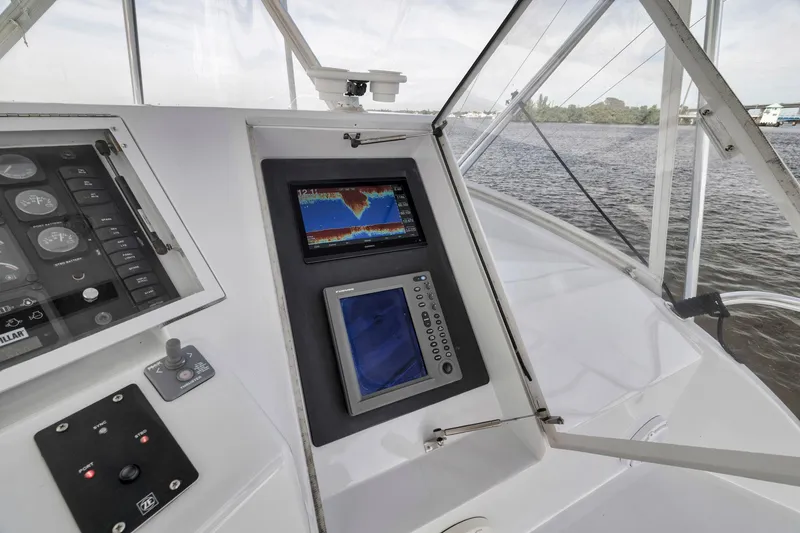 Slide: The Image of Control panel of 1999 Hatteras 60 Convertible yacht with navigation screens. - 42
