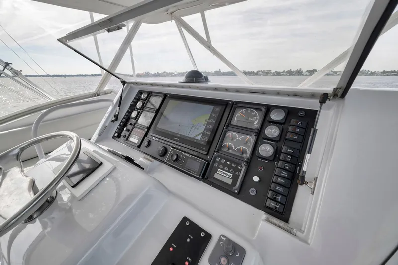 Slide: The Image of Control panel of 1999 Hatteras 60 Convertible yacht with navigation instruments and steering wheel. - 43