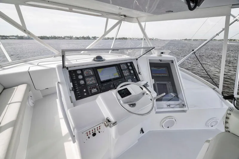 Slide: The Image of 1999 Hatteras 60 Convertible yacht helm with navigation equipment and steering wheel. - 47