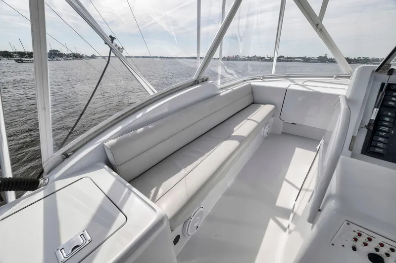 Slide: The Image of 1999 Hatteras 60 Convertible yacht interior with sleek seating and panoramic water views. - 48